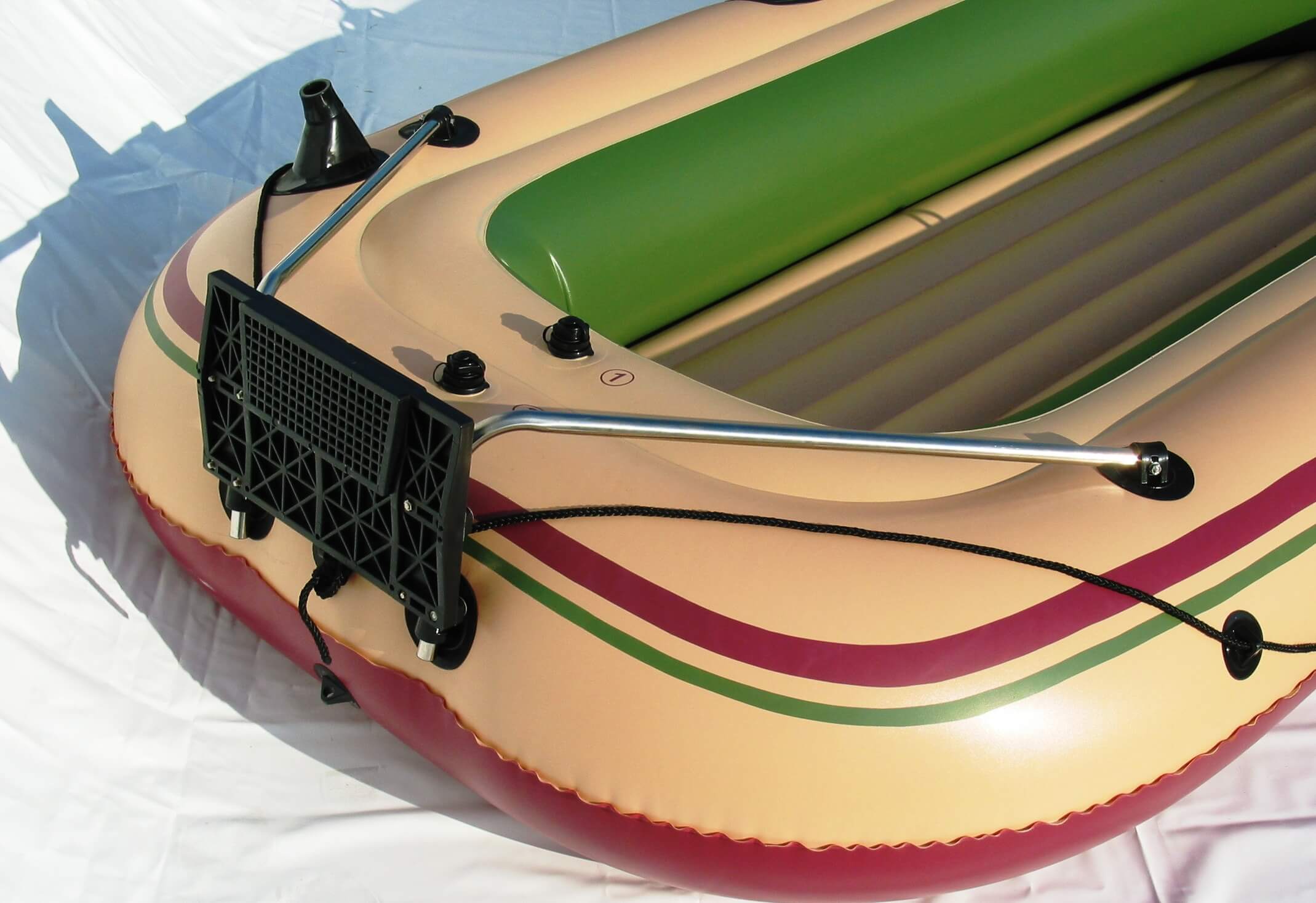 Inflatable boat with a motor attachment on a white background
